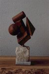 Cubism. Olive wood on white granite base